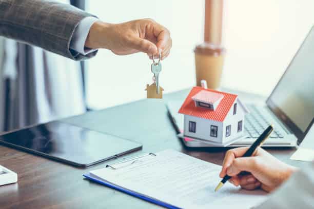 Real estate agent handing over keys - probate sales solicitors