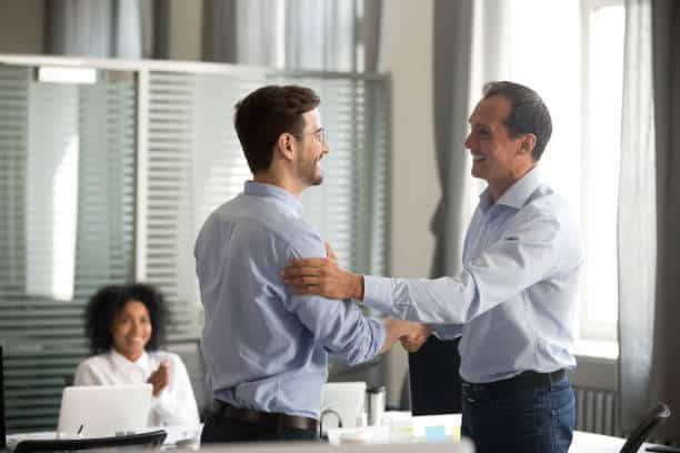 Smiling middle-aged ceo handshaking successful male worker showing respect Smiling middle-aged ceo promoting motivating worker shaking hands congratulating with achievement promising respect bonus thanking for good work, team applauding, employee reward recognition concept Credibility And Professionalism stock pictures, royalty-free photos & images